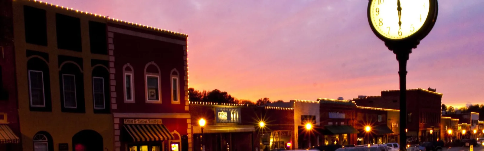 Downtown Acworth, GA at sunset with a street clock