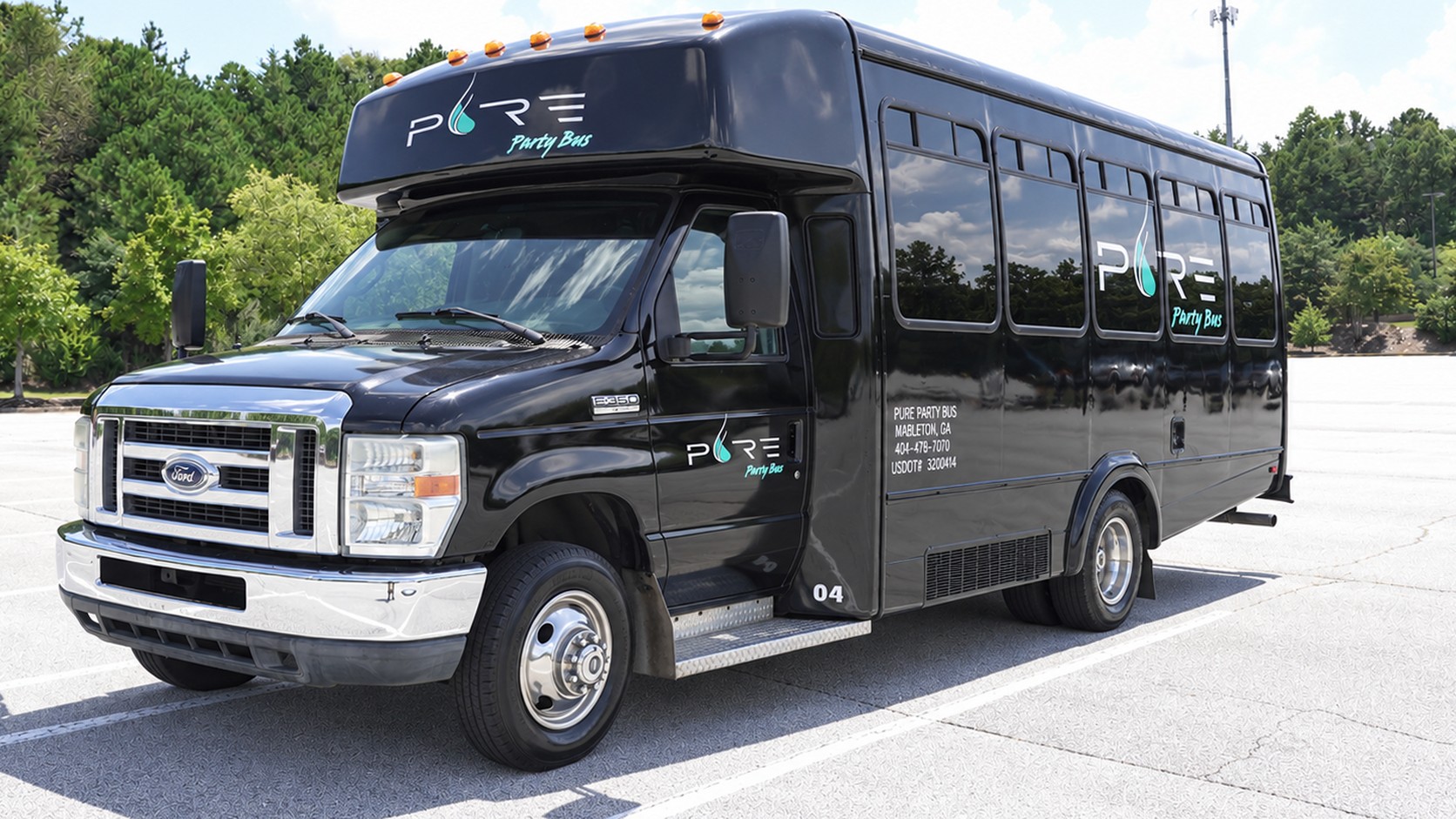Black Pure Party Bus Black Panther, a 16 passenger party bus with the Pure Party Bus logo on the side, parked in Mableton, GA