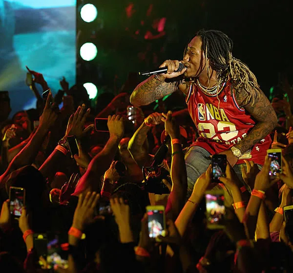 Rapper performing to a crowd at a concert