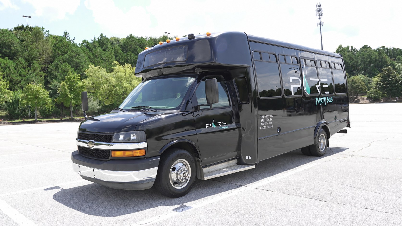 Black Pure Party Bus Miami Nights, a 20 passenger party bus with the Pure Party Bus logo and USDOT number on the side, parked in Mableton, GA