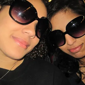 Two smiling Pure Party Bus guests in sunglasses