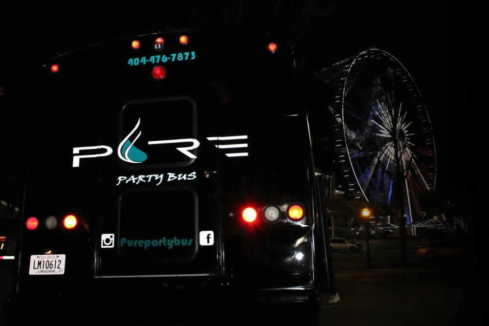 Rear of a Pure Party Bus lit up at night
