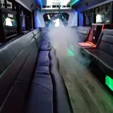 Blu Dream party bus aisle with wood floor and wraparound seating