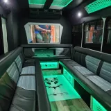 Black Panther party bus interior with green lights and leather seats